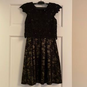 Girls dress size 14, but runs small, color black and gold